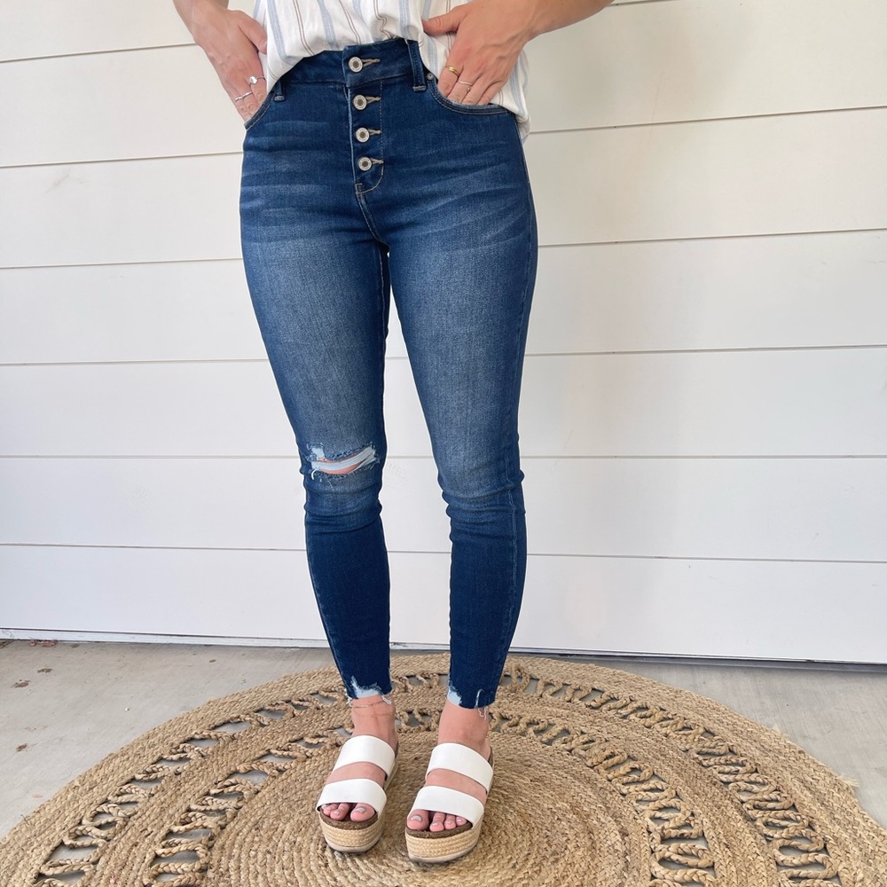Kan Can high rise blue distressed jeans.